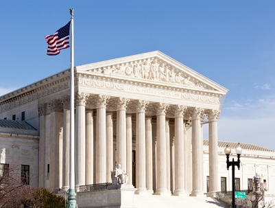A large, light-colored building with columns and steps, likely the Supreme Court building.