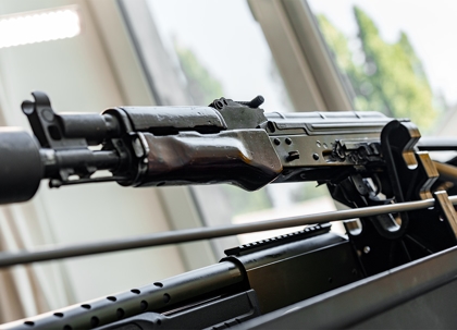 Automatic rifle on stand on the table of the weapons workshop.