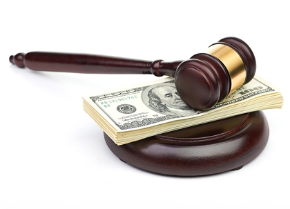 One hundred dollar bills and a wooden gavel.